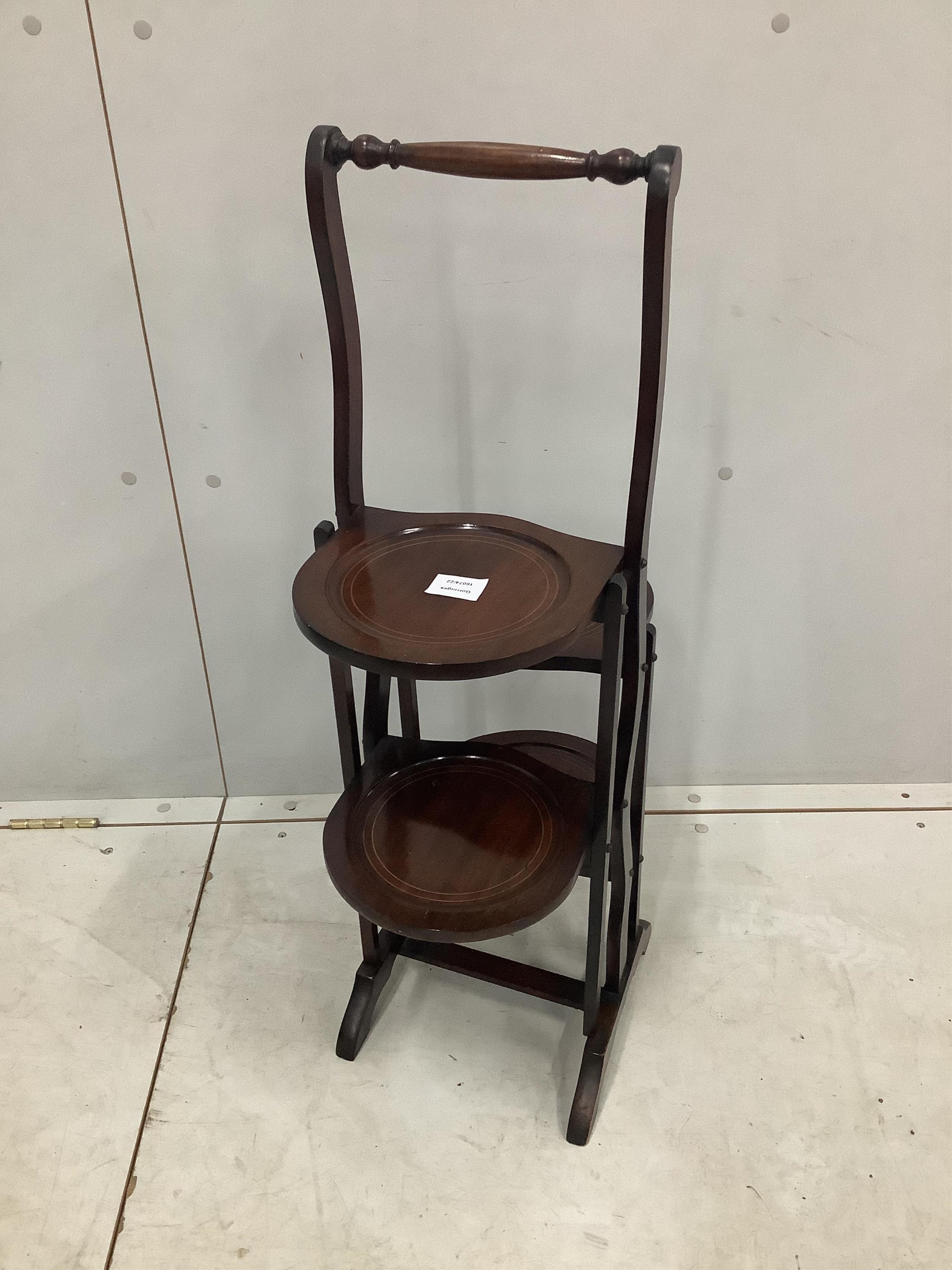 An Edwardian inlaid mahogany four dish folding cake stand, height 86cm. Condition - good